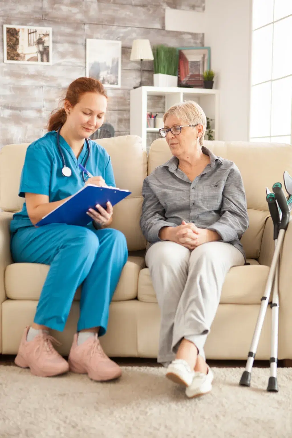 Caregiver smiling while helping a client at home